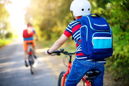 Kid being safe riding his bike to school